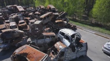 This stock video shows a dump of shot and burned cars in Irpin, Bucha district in 8K resolution