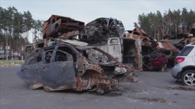 This stock video shows a dump of shot and burned cars in Irpin, Bucha district in 8K resolution
