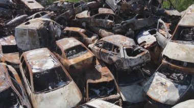 This stock video shows a dump of shot and burned cars in Irpin, Bucha district in 8K resolution