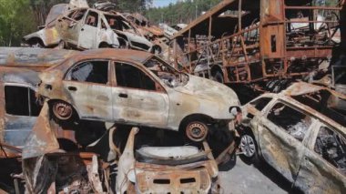 This stock video shows a dump of shot and burned cars in Irpin, Bucha district in 8K resolution