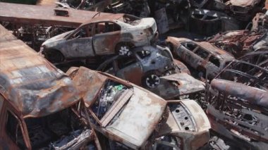 This stock video shows a dump of shot and burned cars in Irpin, Bucha district in 8K resolution