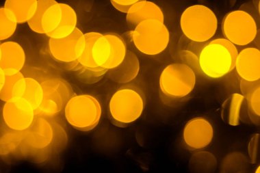 yellow bokeh on a black background. festive background. congratulation.
