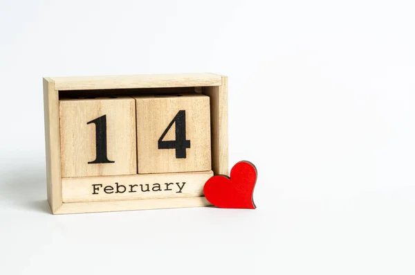 Wooden calendar with date February 14 and red heart on white background with place for text — Stock Fotó