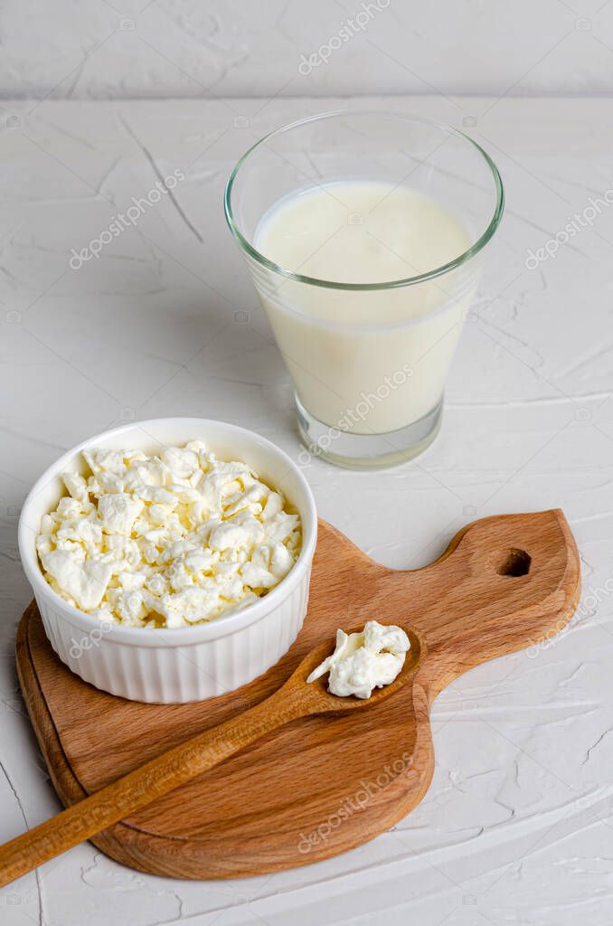 Queso casero cottage en un plato y kéfir en un vaso de vidrio sobre un