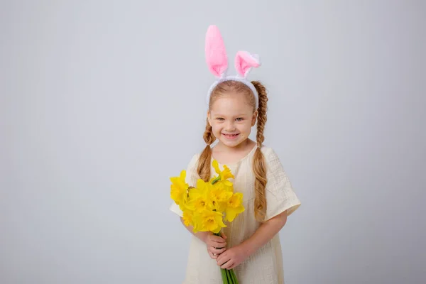 Cute Little Girl Bunny Ears Holds Bouquet Yellow Daffodil Flowers — стоковое фото