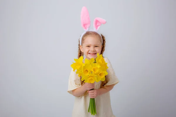 Cute Little Girl Bunny Ears Holds Bouquet Yellow Daffodil Flowers — стоковое фото