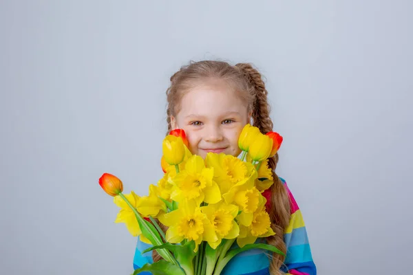 Cute Little Girl Multicolored Sweater Holds Bouquet Spring Flowers White — Stok fotoğraf