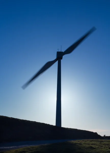 Silhouetted Wind Turbine – stockfoto