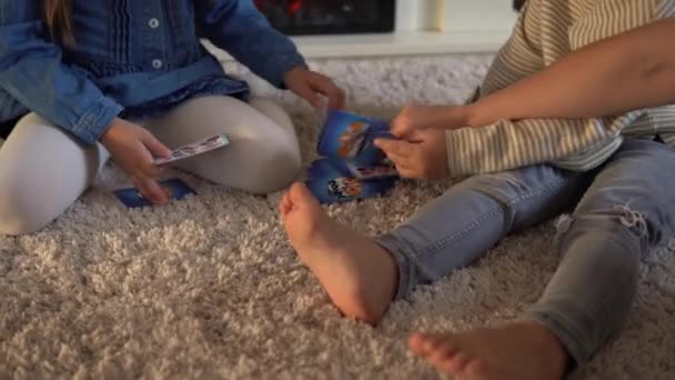 Dětství, vzdělání, hobby, rodina, přátelé, koncept přátelství. Šťastná mladá matka maminka hlídání dětí s malými předškolními dětmi tráví čas hraním karetní hry na podlaze doma u krbu — Stock video