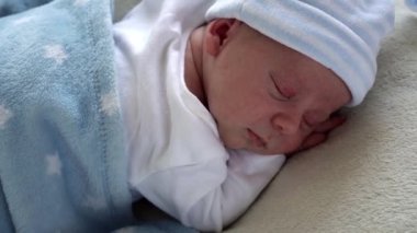 Yakın plan Yeni Doğmuş Bebek Yüzü İlk Günler Mavi Göbek Arkaplanında Tatlı Uyuyan Bebek Portresi. Hayata Başlayan Çocuk Şapka 'da. Bebekler, Doğum, Doğumun İlk Anları, Başlangıç Konsepti