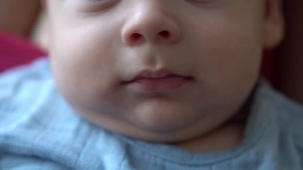 Close-up Chubby Face Of Newborn Baby In Early Days Wake Up Cute Open Mouth Smiling Lips. Infant Child Grimaces After Dream. Kid In First Minutes Of Life Portrait In Macro. Childhood, Infancy Concept — Stockvideo