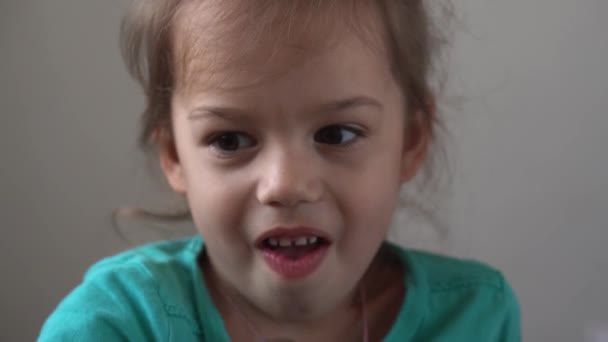 Portrait Funny little preschool girl smiling not combed untidy child looking away thoughtfully sad at home, pretty natural real face. childhood.sincere emotions of ashamed, embarrassed child — Stock Video