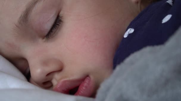 Authentic Cute Little Girl Sleeping Sweetly In Comfortable White and Grey Bed Close Up. Beautiful Tired Child Have Rest Time Gently Soothing. Kid in Crib. Care, Childhood, Parenthood, Life concept — Stock Video © mytrykau 