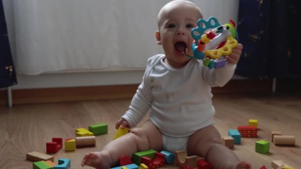 Happy Newborn Baby In Playing Room. Infant Kid Play With Wooden Toys At Home Build Constructions From Geometric Figures. Child Have Spend Time During Motor Skills Game. Childhood, Parenthood Concept — Stock Video