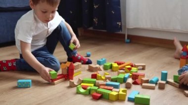 Oyun Salonundaki İki Mutlu Anaokulu Kardeşleri Çocuk Kız Çocuğu. Ev inşaatında aynı yaştaki çocuklar tahta oyuncaklarla oynarlar. Bebek evde çok zaman geçirdi. Çocukluk, Ebeveynlik, Arkadaşlık Konsepti