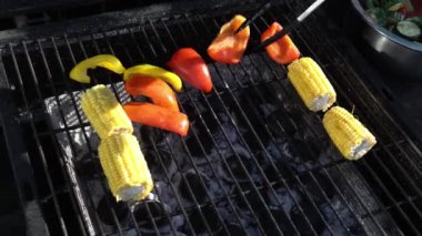 fresh grilled vegetables on barbecue for dinner. Healthy food, summer, family evening, holiday cooking in the garden, food concepts. A man grills zucchini, peppers, and asparagus corn on barbecue.