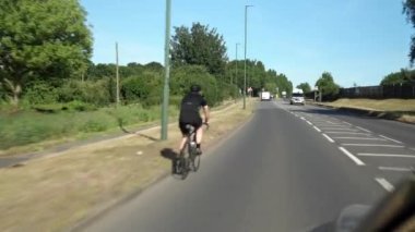Güneşli bir günde Yeşil Ağaçlar 'ın arasından. Araba penceresinden yola, ışıldayan sokaklara ve binalara. Vahşi Doğa Gezisi. Ulaştırma, Seyahat, Meslek, Turizm Konsepti