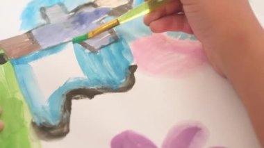 Close up Talented little girl Female Artist Draws Mother Sun Summer Flover drawing at Home. Colorful, Emotional Happy painting with Brush water colors. Contemporary Painter Creating Abstract Modern