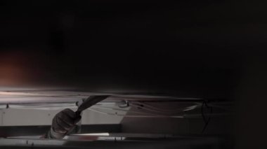 Hard male work on construction site. Two professional workers in special uniforms Contractors Safety Hats repairing ceiling wall inside building. Builders equipment at workplace. industrial premises.