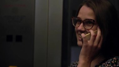 Close shot of young attractive Ukraine female in glasses sitting on moving city metro train. Woman calling typing text message on mobile phone. Pretty Lady waving hands say goodbye. Traveling alone.