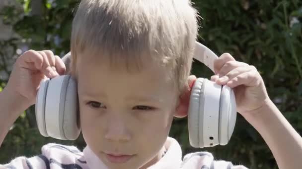 Portrait Cute Little Boy Headphones Listening Music Cheerful Carefree Childhood — Stockvideo