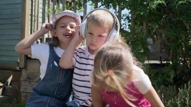Portrait Cute Little Three Children Headphones Listening Music Cheerful Carefree — 图库视频影像