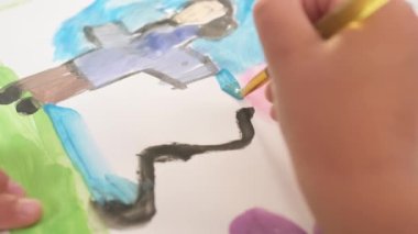 Close up Talented little girl Female Artist Draws Mother Sun Summer Flover drawing at Home. Colorful, Emotional Happy painting with Brush water colors. Contemporary Painter Creating Abstract Modern
