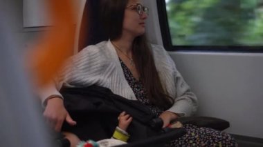 Mom and baby. Happy family with little boy going on railway station. young mother traveling by metro train with a small child. Travel with children. Motherhood, Childcare. Parent with child.