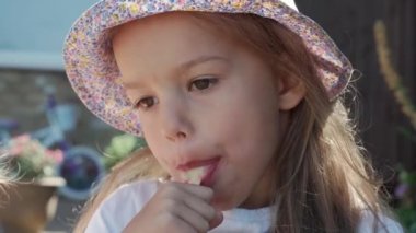 Close up portrait Girl enjoys delicious ice cream cone. Child eating watermelon popsicle. Kid Sibling snack sweets in Home Garden. Summer holiday Hot weather Sunny Day. Childhood, Food Candy Friends.