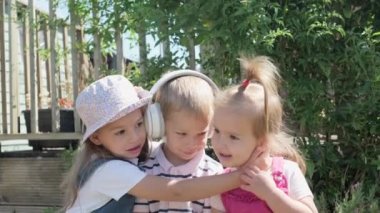 Portrait of Cute Little Three Children With Headphones Listening to Music. Cheerful Carefree Childhood. Preschool Siblings Friends Feeling Free Funky, Good Emotions Life. Home Dancing. Friendship Kids