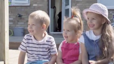 Three cute little Children enjoys delicious ice cream cone. Child eating watermelon popsicle. Kids Siblings snack sweets in Home Garden. Summer holiday Hot weather Sunny Day. Childhood, Food Candy