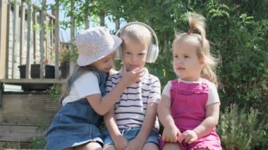 Portrait of Cute Little Three Children With Headphones Listening to Music. Cheerful Carefree Childhood. Preschool Siblings Friends Feeling Free Funky, Good Emotions Life. Home Dancing. Friendship Kids