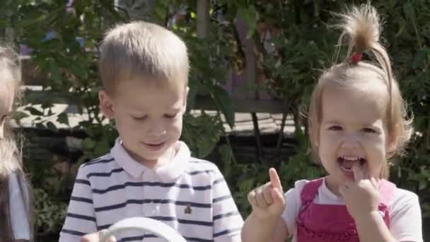 Portrait Cute Little Three Children Sitting Beanch Garden Cheerful Carefree — Stockvideo