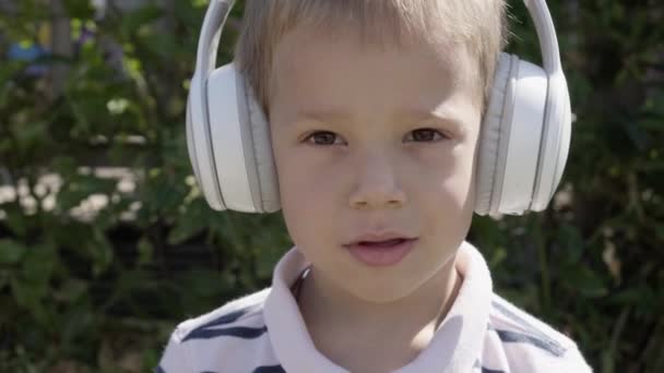 Portrait Cute Little Boy Headphones Listening Music Cheerful Carefree Childhood — Stockvideo