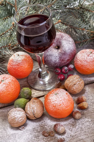 Wine glass with fruits and nuts — Stock Photo, Image