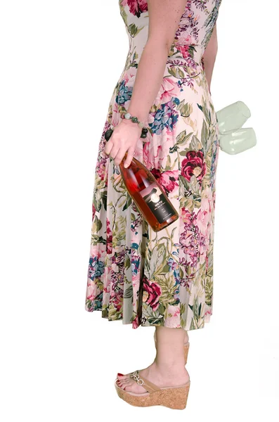 Lady in a color dress with bottle of rose wine — Stock Photo, Image