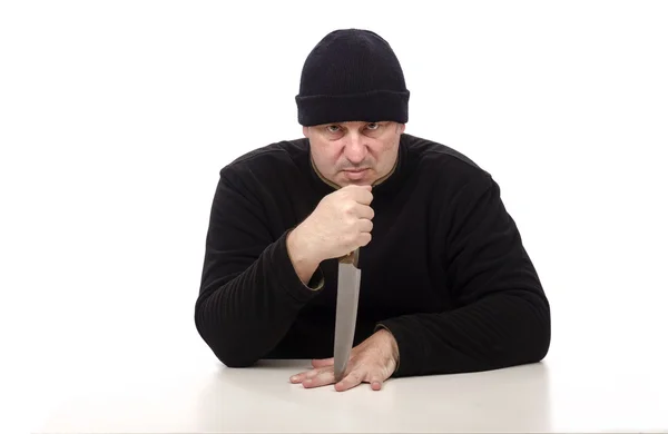 Outlaw man in black clothes threatens with a knife — Stock Photo, Image