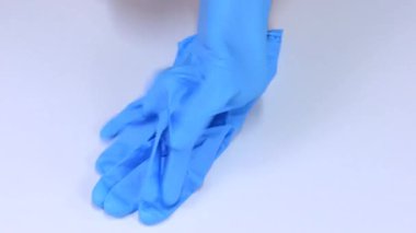 Mavi kauçuk eldiven koyarak doktor