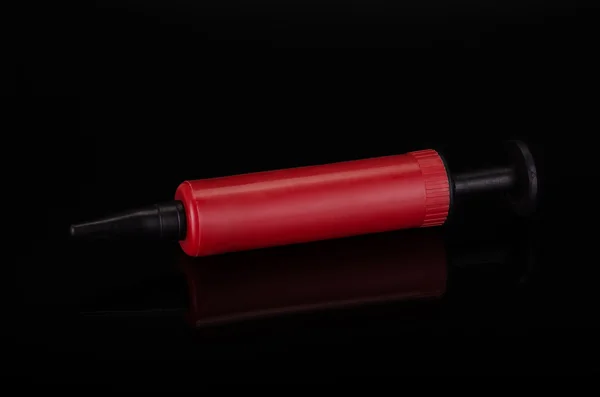 Red plastic syringe — Stock Photo, Image