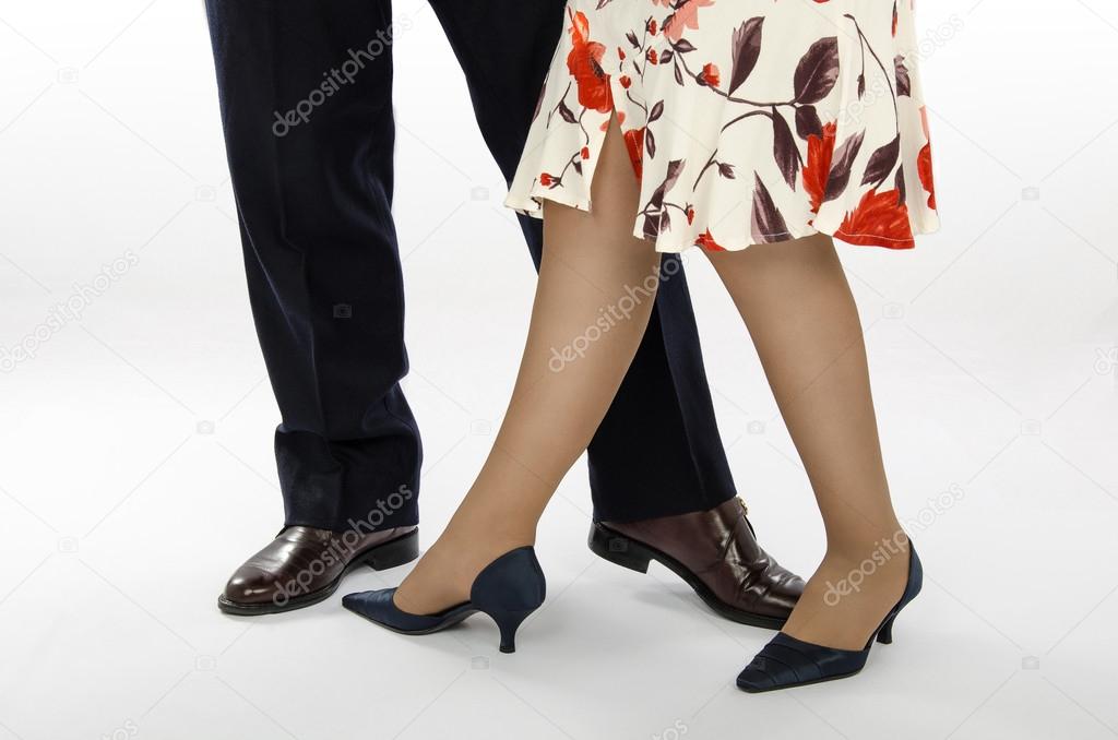 Lady in colorful skirt with a partner show dance position