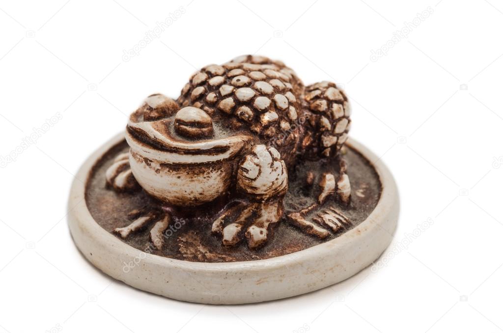 Netsuke toad on a gold coin