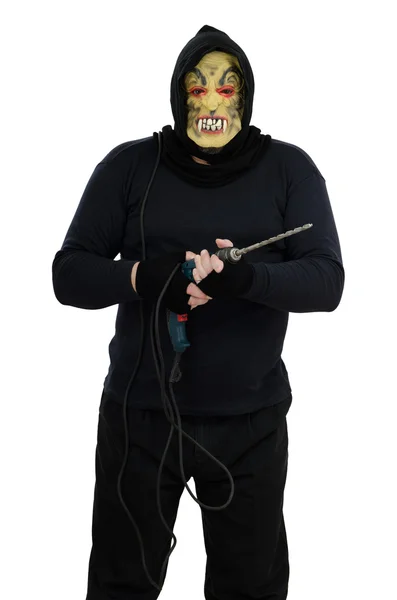 Maniac in a mask holds a electric drill — Stock Photo, Image