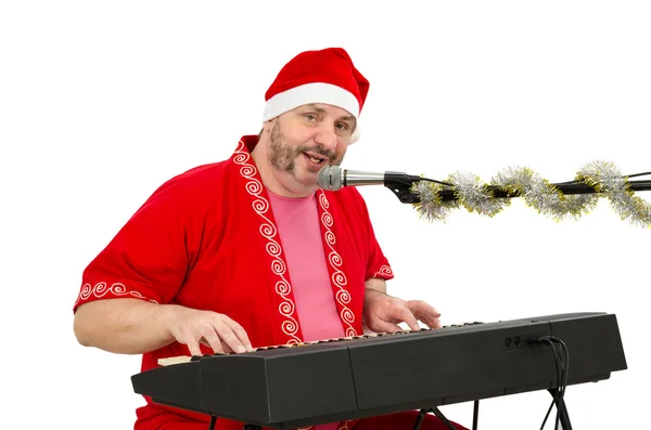 Man wearing Santa suit plays and sings — Stock Photo, Image