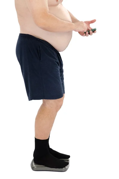 Fat man calls to doctor on scales Stock Photo