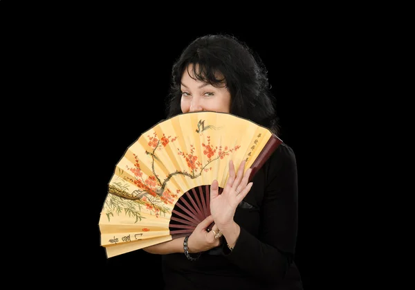 Actress covers her face with Japanese fan — Stock Photo, Image