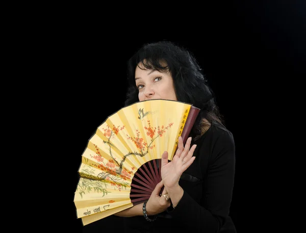 Actress hides her chin behind fan — Stock Photo, Image