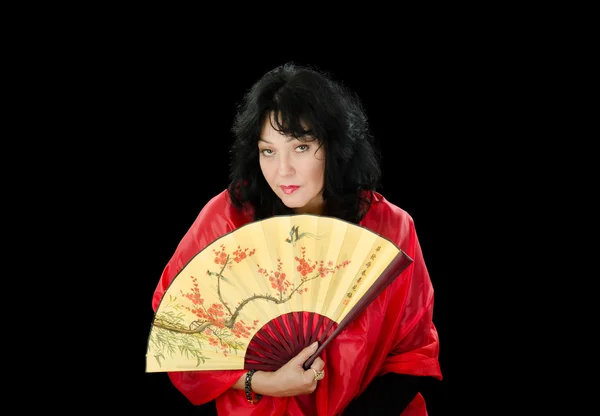 Woman with fan looks askance — Stock Photo, Image