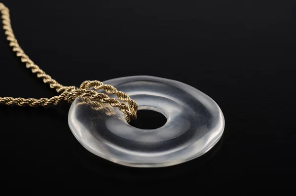 Rock crystal donut on golden chain — Stock Photo, Image