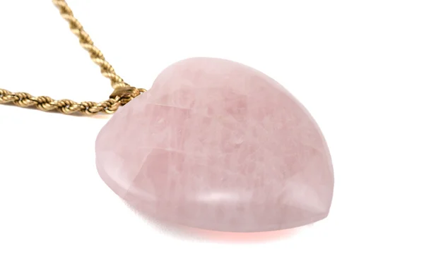 Rose quartz heart with golden chain on white — Stock Photo, Image