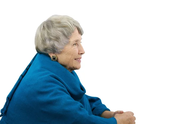 Alte grauhaarige Frau im blauen Poncho — Stockfoto